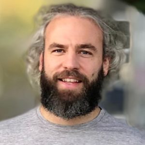 photograph of a smiling grizzly middle-aged service designer